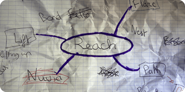 A crumpled paper with brainstorming ideas leading to the name "Reach," symbolizing the creative journey behind the mental health platform's identity.