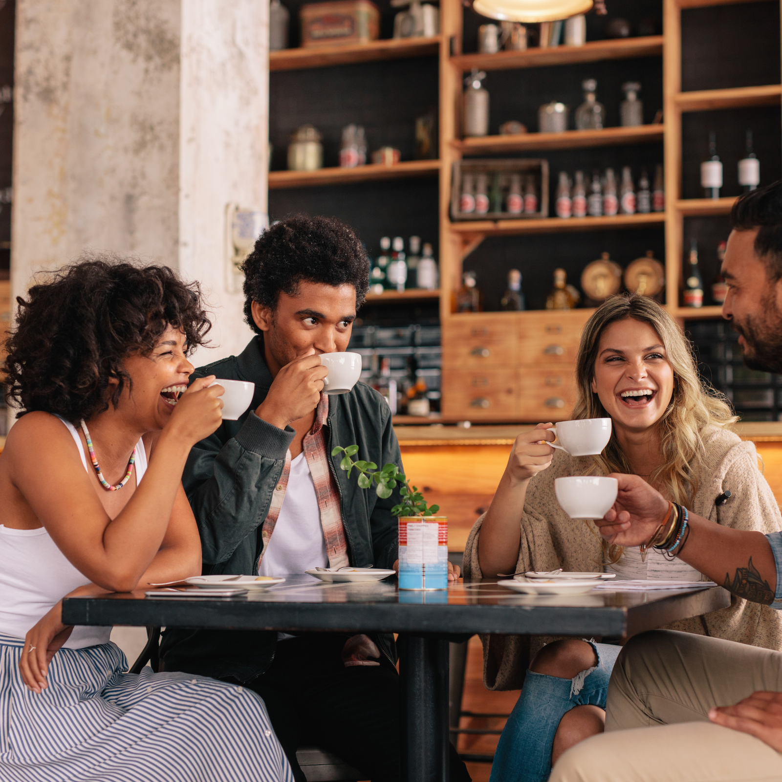 A group of friends enjoying coffee together, showcasing the warmth and connection Reach fosters through emotional support and shared experiences