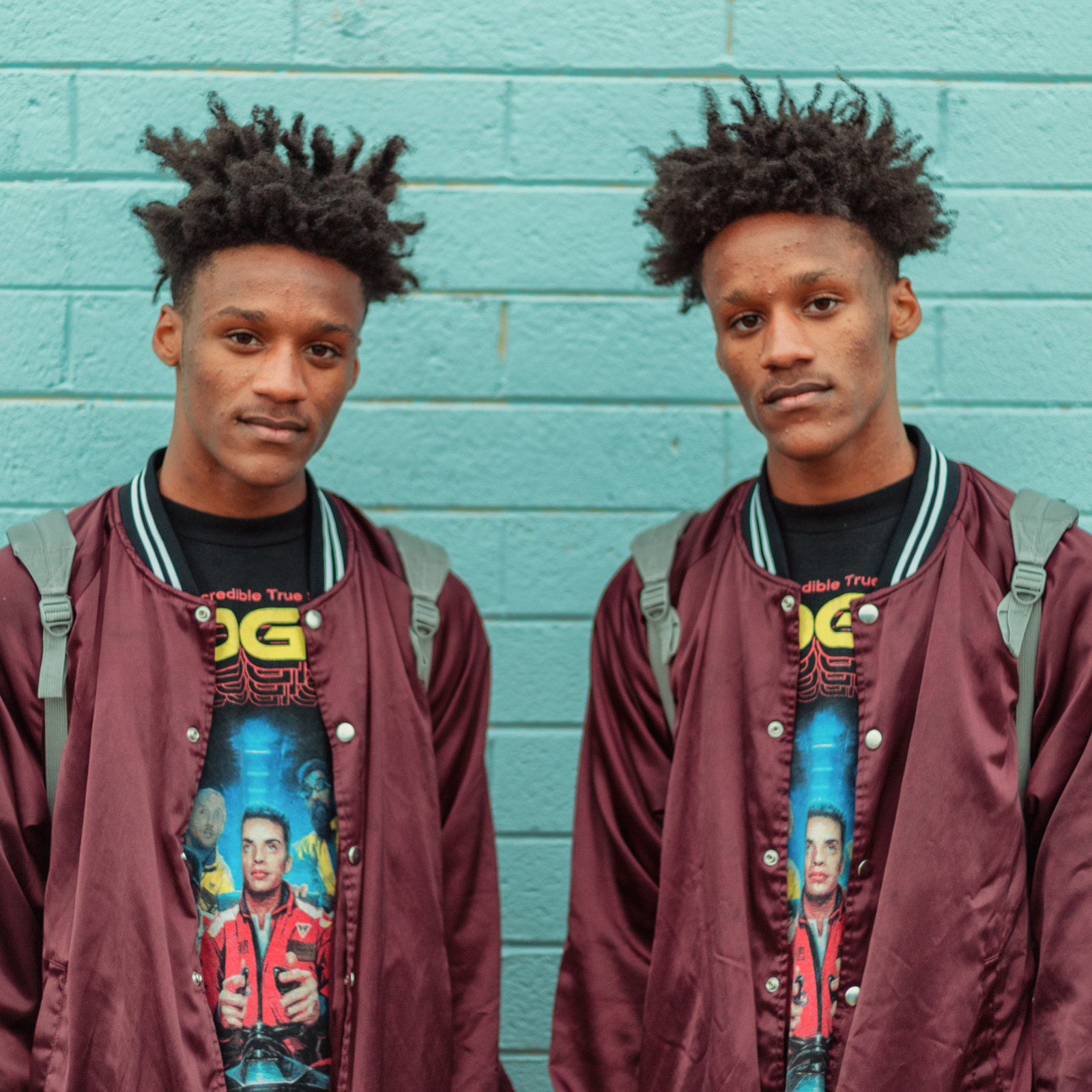 Two individuals standing side by side against a teal wall, symbolizing the power of shared experiences and peer-to-peer support in mental health